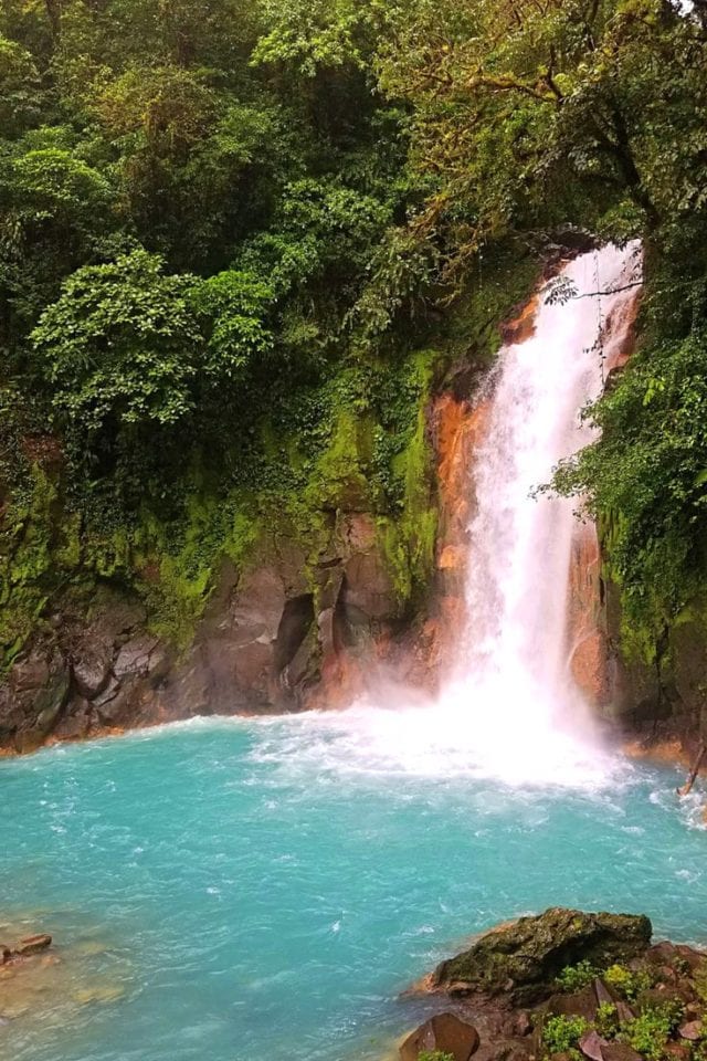 Have you dreamed of visiting Rio Celeste Waterfall in Costa Rica's Tenorio Volcano National Park? Click pin for our complete guide including the 13 things you need to know before you visit this bucket list Costa Rican natural wonder. #CostaRica #Waterfalls #RioCeleste