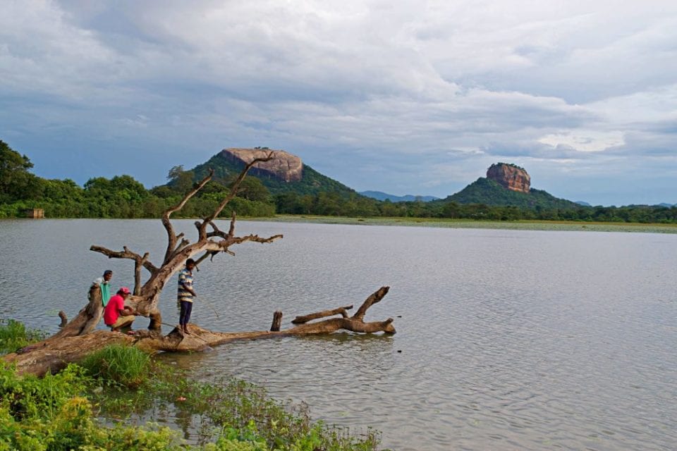 Pidurangala Rock and Sigiriya Rock reflecting across a lake in Sri Lanka