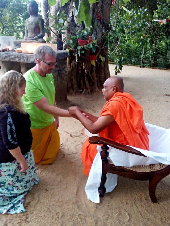 Ed and Jenn being blessed by a Buddhist monk