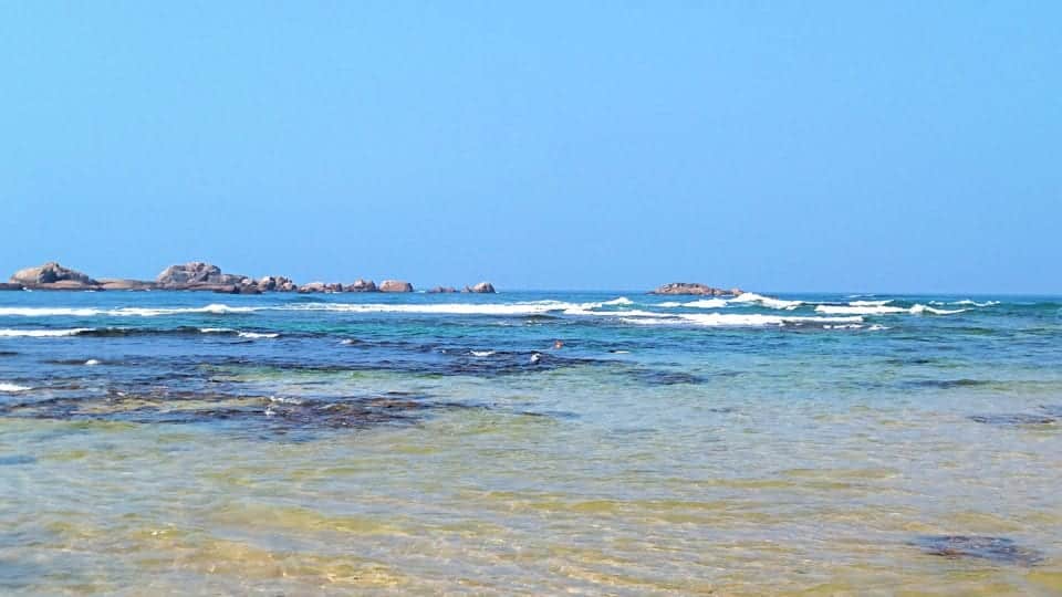 See the waves breaking on the outer reef and black structure of the inner Hikkaduwa Coral Reef.