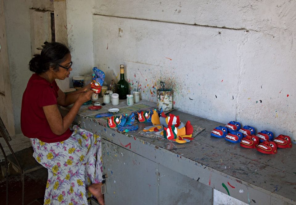 A loca craftsman creating art at the Ambalangoda Mask Workshop and Museum in Sri Lanka.