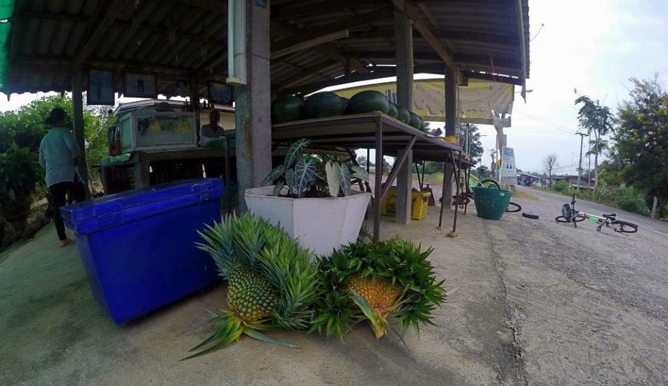 Fruit stand in Thailand with heart shaped pineapples for temple donations