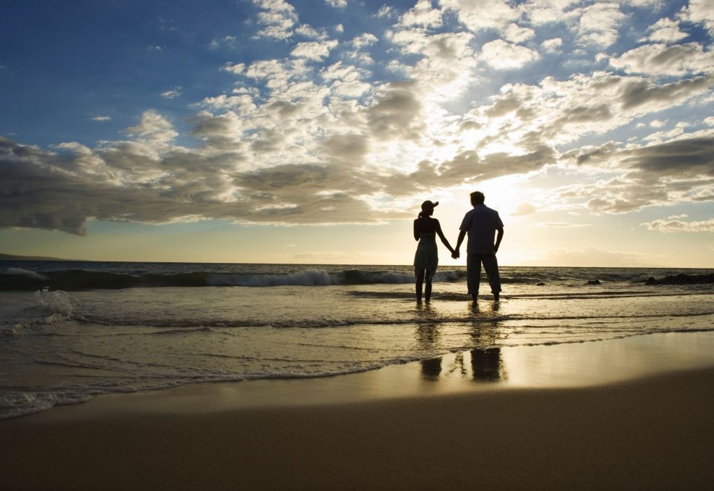 Couple at sunset on Beach via Canva