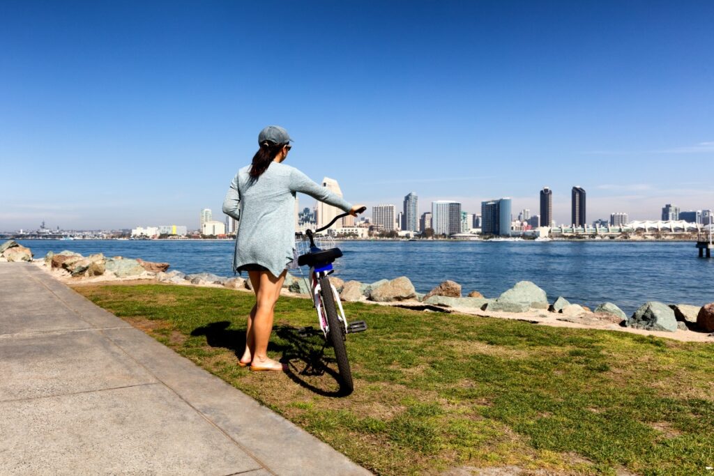 Woman enjoying biking near bay of San Diego California