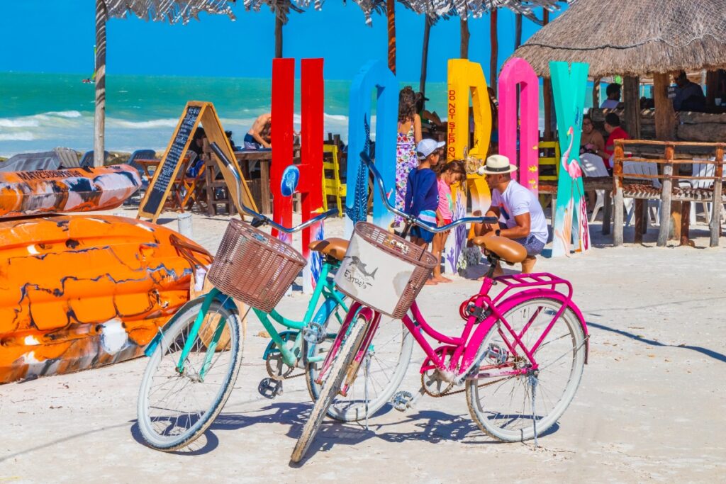 Holbox Mexico 21. December 2021 Colorful welcome letters and sign on the beautiful Holbox island sandbank and beach with waves turquoise water and blue sky in Quintana Roo Mexico.