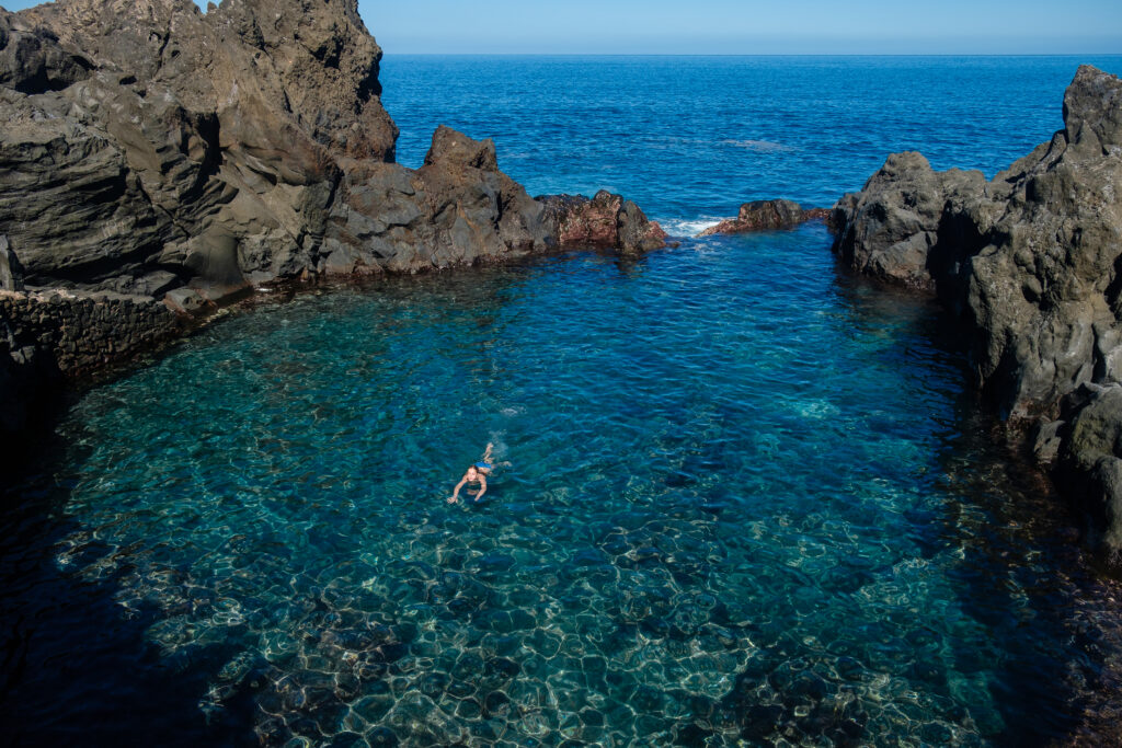 girl swimming in natural ocean swimming pool on Tenerife island. outdoor shot in Spain. copy space.
