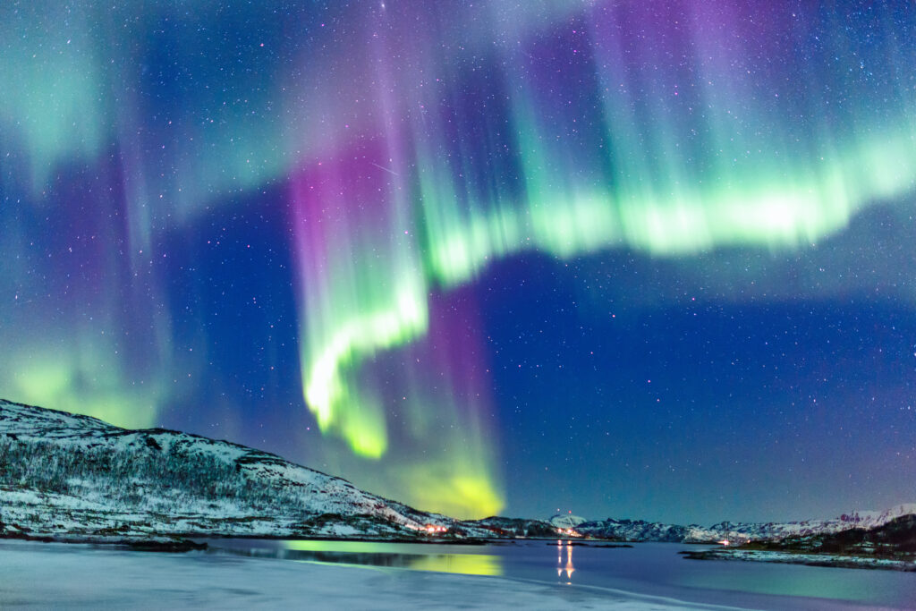 Incredible Northern lights Aurora Borealis activity above the coast in Norway