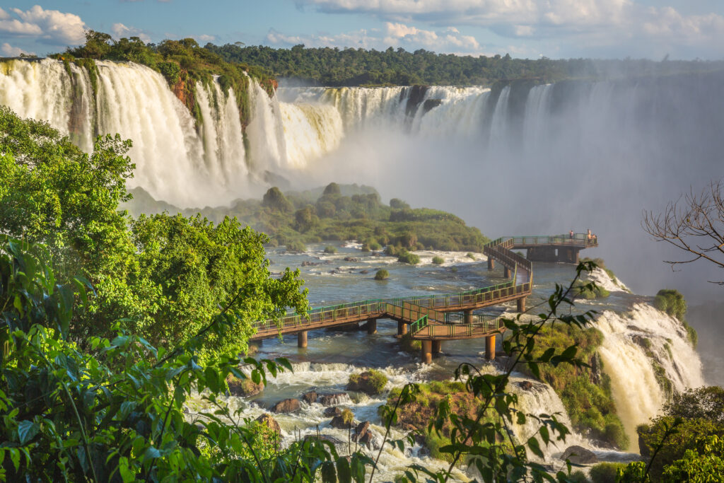 Iguacu falls in southern Brazil at golden sunset, blurred waters, South America