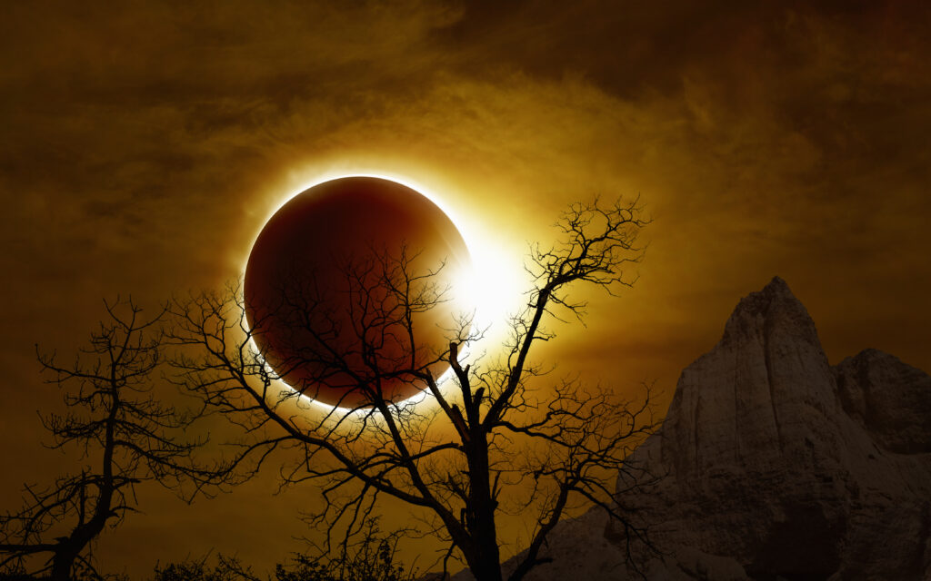 Total solar eclipse, mysterious natural phenomenon when Moon passes between planet Earth and Sun, silhouette of withered tree and mountains