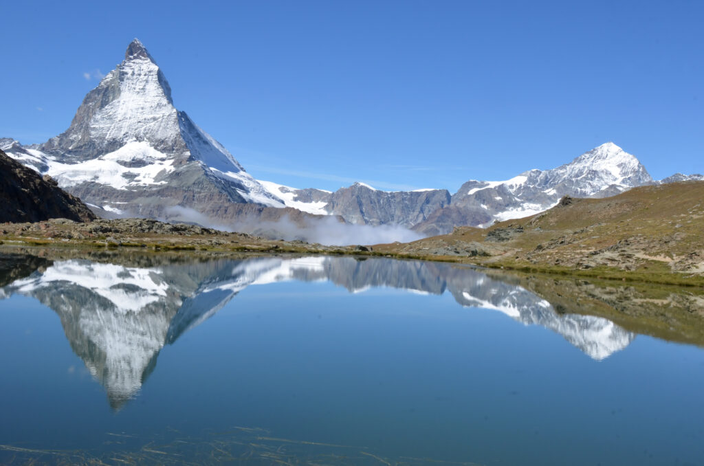 The magnificent Matterhorn with its reflection in a smooth lake, the Riffelsee. In the southern swiss alps above Zermatt
