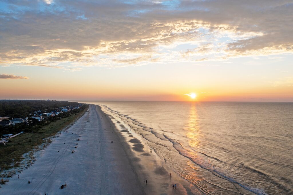 Bird's-eye view of Coligny beach on Hilton Head Island.Ocean view at sunset with trees and hotels in the foreground