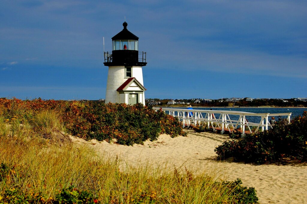 Nantucket Island, Massachusetts Branch Point lighthouse capped by a single fresnel light encased in a black cupola sits on a sandy island