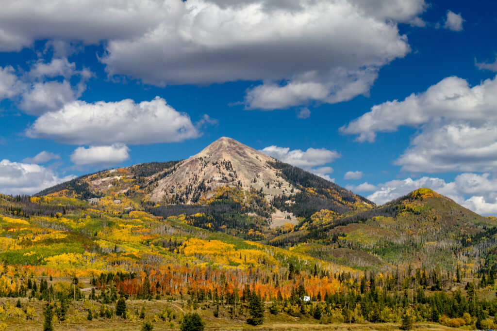 Hahn Peak near Steamboat Lake State Park with changing Aspen trees on mountain slopes on sunny autumn afternoon