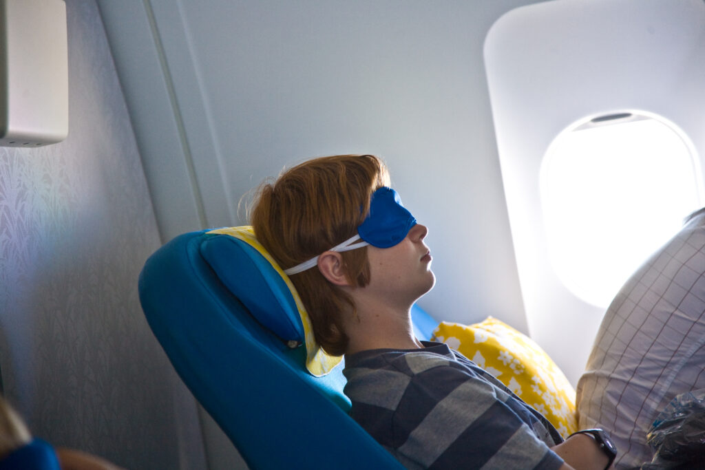 young passenger sleeping in the business class