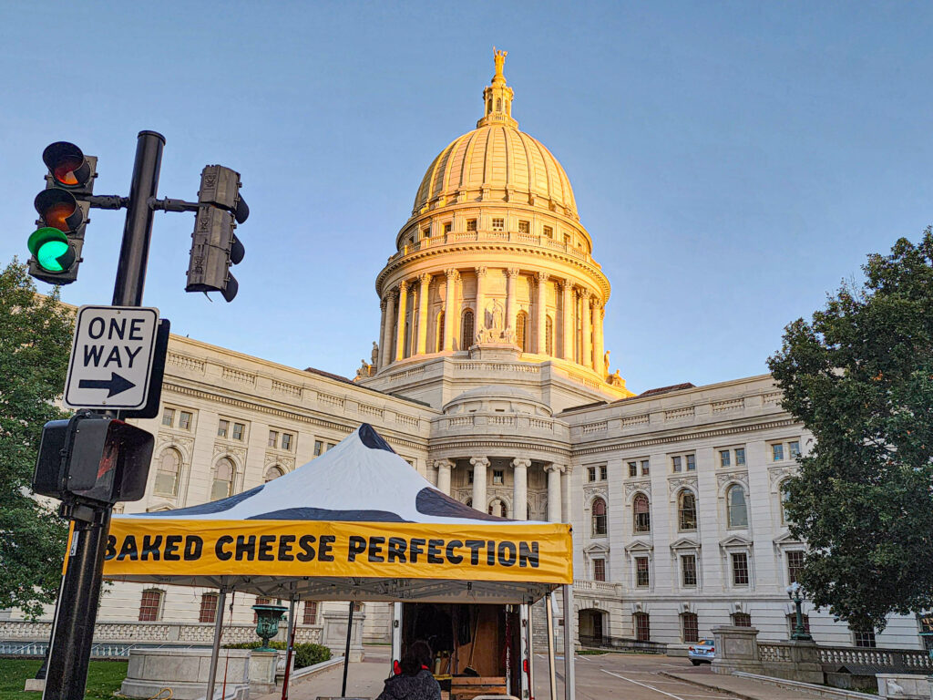 Madison Wisconsin Capital with a Baked Cheese Perfection sign - Cheese Curd Showdown - The Battle for the Best Curds in Madison Wi.