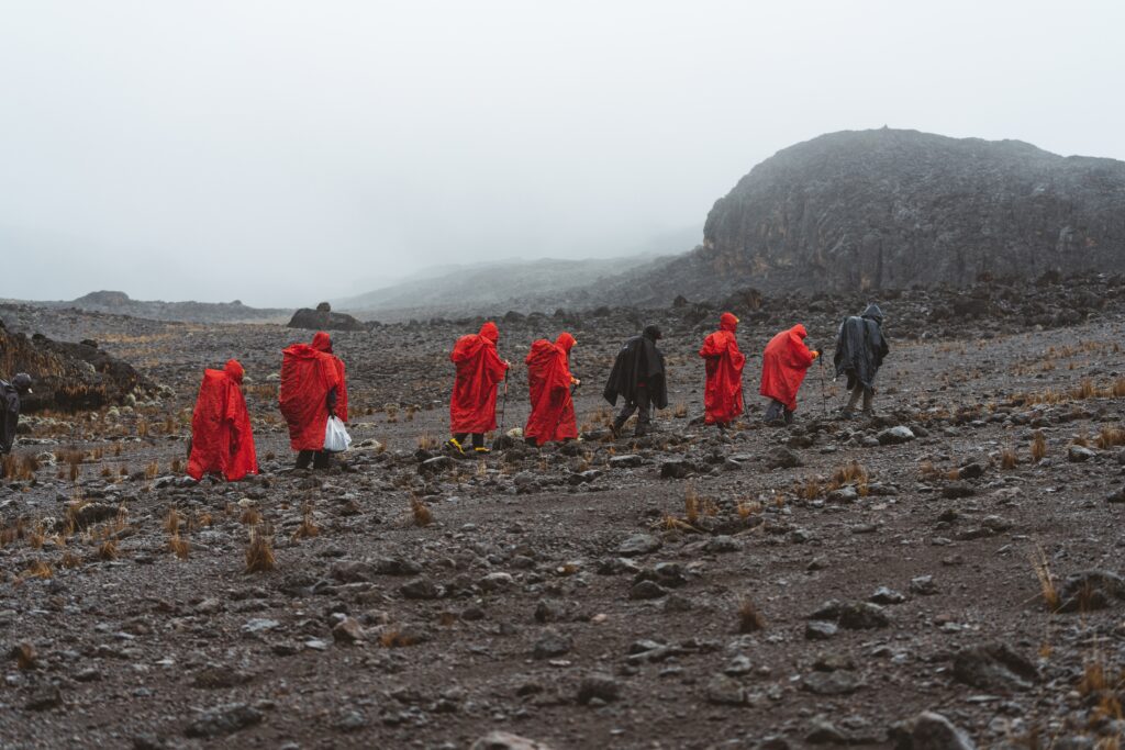 People hiking in the rain on Mt. Kilimanjaro