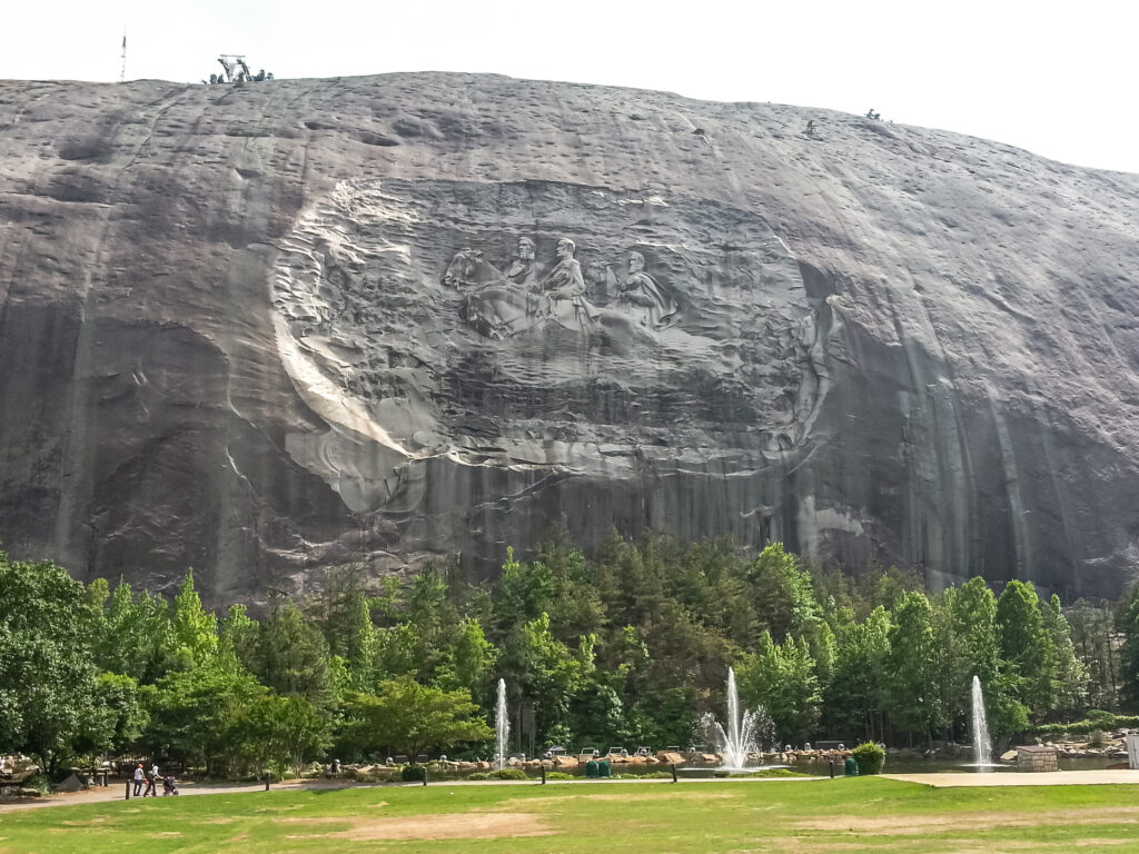 Stone Mountain, Georgia.  People gather at the famous Confederate memorial sculpture in Stone Mountain Park depicting General Stonewall Jackson, Robert E. Lee, and President Jefferson Davis